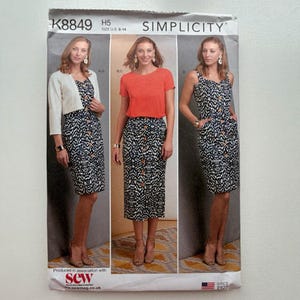 May include: Simplicity sewing pattern K8849 for dresses and skirts. The pattern features three different outfit options, including a dress with a button-down skirt, a skirt with a button-down front, and a dress with a sweetheart neckline. The pattern size is U.S. 6-14.