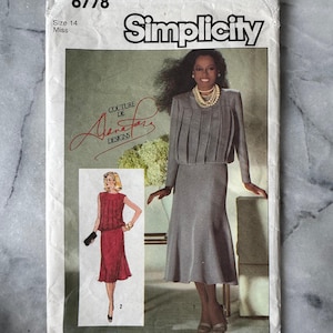May include: A vintage Simplicity sewing pattern, size 14 Miss, showcasing a grey dress and jacket outfit. The pattern cover includes a smaller image of a red dress and the text "COUTURE DE A.J. DESIGNS".