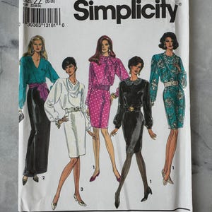 May include: A vintage Simplicity sewing pattern envelope showing illustrations of women's fashion designs. The envelope is white with the number 8063 and the Simplicity logo. The designs include dresses and separates.
