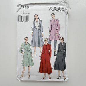 May include: A Vogue Basic Design sewing pattern envelope V9040 featuring illustrations of five different coat styles in various colours including light blue, pink, light green, red, and dark grey, with size range E5 14-16-18-20-22 printed on the front.