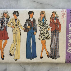 May include: Vintage Simplicity sewing pattern, size 13/14, featuring illustrations of various women's outfits, including suits and dresses. The pattern includes bust measurements of 33 1/2 inches. The cover is a light beige color with the word "Simplicity" in purple.