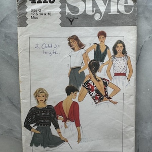 May include: A vintage sewing pattern titled "Style" with the number 4115. The pattern includes illustrations of various tops and dresses. The size is listed as O, 12, 14, and 16. The pattern is printed on aged paper.
