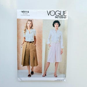 May include: Vogue Patterns V2115 sewing pattern envelope featuring two views of a button-down shirt paired with wide-leg culottes. View B shows a tan pair, while View A displays a light pink pair. The text V2115 and size range Y5 are printed.