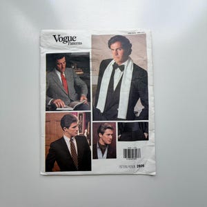 May include: Vogue Patterns sewing pattern with images of men in suits and formal attire. The pattern includes various styles, such as blazers, ties, and scarves. The pattern number is 2826.