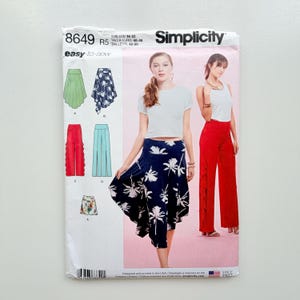May include: Simplicity sewing pattern 8649, with illustrations of skirts and trousers. The pattern includes sizes UK 18-26 and is easy-to-sew. The cover shows a woman wearing a navy blue skirt with a white floral design.