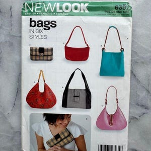 May include: A New Look sewing pattern for bags in six styles. The pattern shows different bag designs, such as a red shoulder bag, a teal tote, and a pink hobo bag. The pattern includes the text 'bags in six styles'.