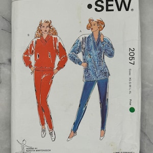 May include: A vintage Kwik Sew sewing pattern, pattern number 2057, showing illustrations of two outfits. One is a red tracksuit, the other a blue patterned top with blue trousers. The pattern sizes are XS-S-M-L-XL.