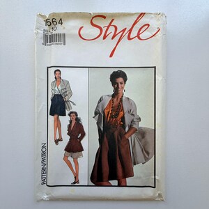 May include: Vintage sewing pattern titled "Style" with illustrations of women's clothing. The pattern envelope is off-white with red script and includes a size 10. The images depict a jacket, skirt, and shorts ensemble.