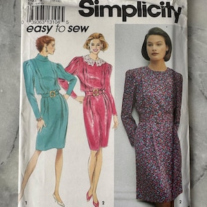 May include: Simplicity sewing pattern 8044, size Y (18-22). The package features illustrations of three dresses: a teal dress, a pink dress, and a floral print dress. The text "easy to sew" is also visible.