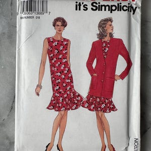 May include: A vintage sewing pattern packet showing illustrations of two dresses. The dresses are red with a white floral design. The packet has the text "It's SO EASY it's Simplicity".