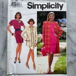 May include: A vintage Simplicity sewing pattern envelope featuring illustrations of women's fashions. The envelope is white with the Simplicity logo and pattern number 7664. The illustrations depict a dress, jacket, and coat in shades of pink and cream.