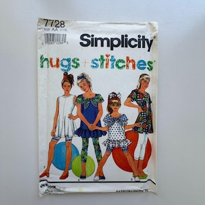May include: A vintage Simplicity sewing pattern envelope with illustrations of children's clothing designs. The envelope has the text "hugs + stitches" and the number "7728". The size is AA (7-10).