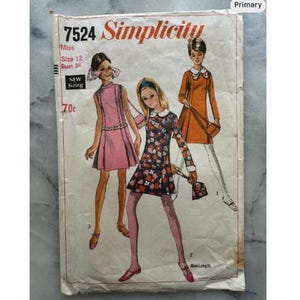 May include: Vintage Simplicity sewing pattern 7524 featuring illustrations of three women in dresses. The pattern includes sizing information for Misses, size 12, bust 34. The cover is aged with the text "New Sizing" and the price 70¢.