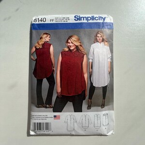 May include: Simplicity sewing pattern 8140. The pattern features three women modeling different shirt styles. The pattern includes sizes 18W-24W. The main colours are red and white. The pattern is printed in the USA.