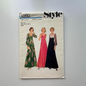 May include: Vintage sewing pattern featuring three long dresses. The pattern includes a green floral dress, a red dress, and a black dress with silver accents. The pattern is size 12, with a bust measurement of 34 inches. The pattern is labeled "Style".