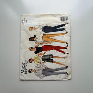 May include: A vintage Vogue basic design sewing pattern. The cover features illustrations of women in various outfits, including pantsuits, skirts, and blouses. The pattern number is 2946.
