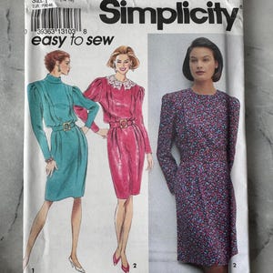 May include: A vintage Simplicity sewing pattern, featuring illustrations of three different dress designs. The pattern cover includes the number 8044, size P (12-16), and the text "easy to sew". The dresses are in teal, pink, and floral print.