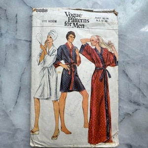 May include: Vintage Vogue Patterns for Men sewing pattern. The cover shows illustrations of three figures in robes. The pattern is labelled "Miss Medium" and includes the text "Vogue Patterns for Men". The cover is slightly worn.