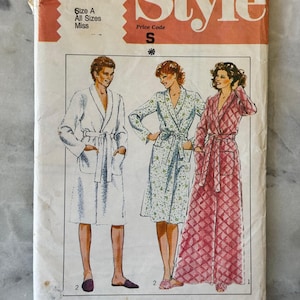 May include: Vintage sewing pattern labelled "Style" with illustrations of three robes. The pattern includes the number 3655, size A, and price code S. The robes are in white, floral, and pink diamond patterns.