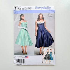 May include: A Simplicity 1155 sewing pattern envelope for a 1950s vintage style dress. The cover displays two variations of the dress in mint green and navy blue, with a small inset showing black and blue versions. Includes US size 20W-28W.