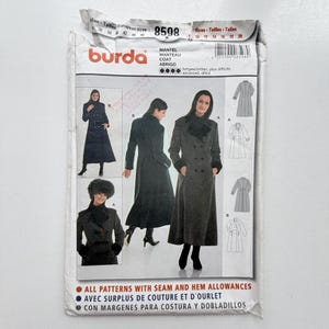 May include: A Burda 8598 sewing pattern envelope for a long coat. The front displays illustrations and photographs of a double-breasted coat with a collar, long sleeves, and a flared hem. Text includes "MANTEL MANTEAU COAT ABRIGO" and sizing info.