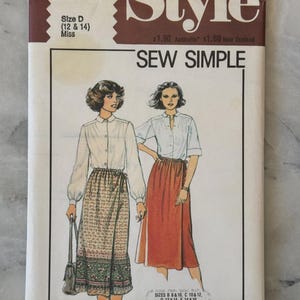 May include: A vintage "Style" sewing pattern, number 2576, featuring illustrations of two women in blouses and skirts. The cover text reads "SEW SIMPLE". Size D (12 & 14) is specified. The pattern is for Miss sizes.
