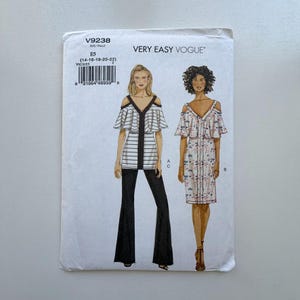 May include: A sewing pattern by Very Easy Vogue, V9238, featuring two off-the-shoulder designs. One is a striped top with flared pants, and the other is a floral print dress. The pattern size is E5 (14-16-18-20-22).