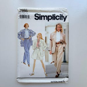 May include: Simplicity sewing pattern 7986 featuring illustrations of women's suits and separates. The pattern includes a blazer, pants, and skirt. The cover has the Simplicity logo and the size range H (10-16).