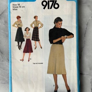May include: A vintage Simplicity sewing pattern, size 16, featuring illustrations of women's skirts. The pattern cover is blue with the Simplicity logo and the number 9176. The waist size is 76 cm.