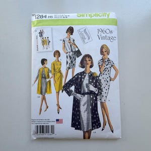 May include: A vintage Simplicity sewing pattern from the 1960s. The pattern features illustrations of women in various dresses and coats. The cover is primarily green, white, and black, with the text "1960s Vintage" prominently displayed.