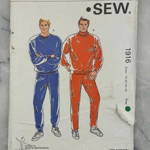 May include: A vintage Kwik Sew pattern envelope, pattern 1916, featuring illustrations of two athletic outfits. The outfits are a blue v-neck sweatshirt and pants, and an orange turtleneck sweatshirt and pants. The envelope includes the text "KWIK SEW" and "Pattern 1916".