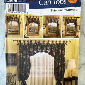 May include: A Simplicity Home Decorating pattern for window treatments, showcasing can top designs. The package includes Spanish instructions and illustrates various window treatment styles. The pattern number is 5696. Measurements are in centimeters.
