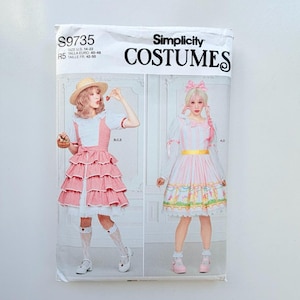 May include: Simplicity Costumes sewing pattern S9735 for sizes 14-22. The package features two dress designs: one with a red and white gingham tiered skirt and straw hat, and another with a pink striped bodice, yellow waistband, and floral hem.