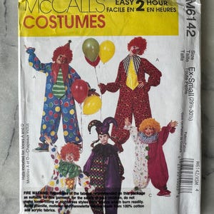 May include: A McCall's Costumes sewing pattern packet featuring clown costumes. The packet has images of several clown outfits with colorful polka dots, patterns, and accessories. The text on the packet reads "Easy 2 Hour" and "Ex-Small".