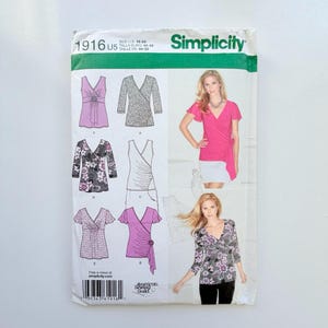 May include: Simplicity sewing pattern 1916 U5 for sizes 18-24. The envelope features illustrations of six different wrap-style top variations with various sleeve lengths and floral or solid patterns, alongside photographs of two models wearing the finished tops.