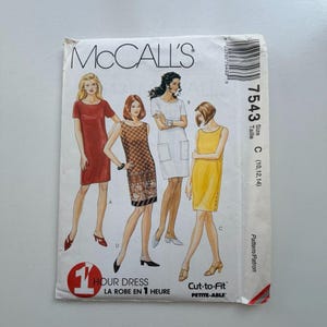 May include: McCall's sewing pattern envelope featuring illustrations of four different dresses. The envelope has the number 7543 and the text "1 Hour Dress" and "Cut-to-Fit Petite-Able". The dresses are in red, brown, white, and yellow.