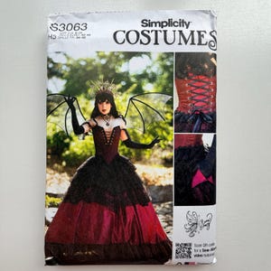 May include: Simplicity Costumes sewing pattern. The cover shows a woman in a gothic costume with a burgundy and black dress, bat wings, and a crown. The pattern includes sizes 8-14.