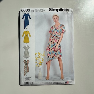 May include: A Simplicity sewing pattern with a woman in a floral dress. The pattern includes various dress designs, size details, and the Simplicity logo. The pattern is labelled "8688 R5" and "Since 1927".