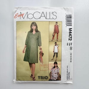 May include: McCall's M4472 sewing pattern envelope for sizes DD (12-14-16-18). The front features illustrations of a wrap dress, a sleeveless tunic with trousers, a sleeveless tunic with capris, and a short-sleeved floral print top.