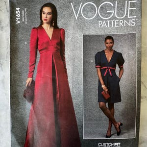 May include: Vogue Patterns sewing pattern featuring two dress designs. One dress is a long, red, formal gown with long sleeves and a V-neck. The other is a navy blue dress with short sleeves and a red bow. The pattern includes sizes 6-14.