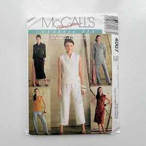 May include: A McCall's Classic Fit sewing pattern envelope, number 4007, featuring illustrations of various wrap-style tops, trousers, and dresses. The text includes 'McCall's', 'Classic Fit', 'The Perfect Wardrobe', and 'Le Wardrobe Perfecte'.