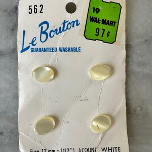 May include: A vintage card of four white oval Le Bouton buttons. The card reads "GUARANTEED WASHABLE" and "Size 12 mm - (1/2") 4 COUNT WHITE." A green Wal-Mart price sticker is affixed to the card.