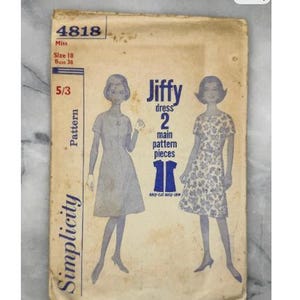 May include: Vintage Simplicity sewing pattern, style 4818, for a Jiffy dress. The pattern is size 18, bust 38, and includes two main pieces. The cover is aged with a cream background and blue text and illustrations. Measurements are in inches.