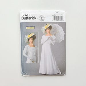 May include: A Butterick B6610 sewing pattern envelope featuring a white long-sleeved dress with a square neckline. The cover displays two images of a person wearing the dress, a hat with yellow flowers, and holding a white lace parasol.