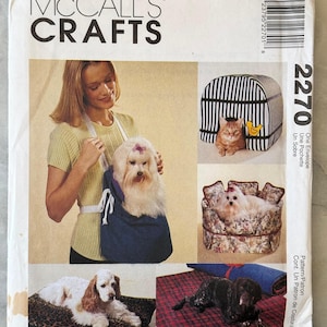 May include: McCall's Crafts sewing pattern for pet accessories. The pattern includes instructions for a pet carrier, a striped pet house, a floral pet bed, a leopard print pet bed, and a red plaid pet bed. The pattern number is 2270.