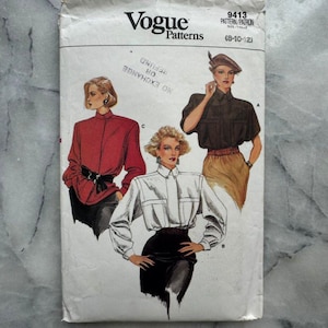 May include: A vintage Vogue Patterns sewing pattern packet. The packet features illustrations of women's blouses and shirts in red, white, and brown. The pattern number is 9413, and the size range is 8-12.