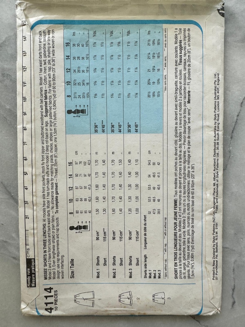 May include: A vintage sewing pattern for misses' shorts in three lengths, featuring side front pockets, mock fly front zipper, and buttoned waistband. Includes fabric requirements and size charts in inches and centimeters.