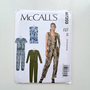 May include: A McCall's M7203 sewing pattern envelope featuring illustrations of four jumpsuit variations. The designs include sleeveless, short-sleeve, and long-sleeve options with V-necklines and button-front closures in various animal and solid prints.
