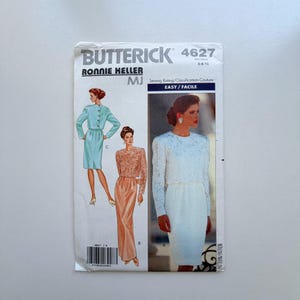 May include: A vintage Butterick sewing pattern, model 4627, featuring designs by Ronnie Heller. The pattern includes illustrations of women's clothing, including a skirt suit and a dress. The text on the pattern indicates an easy sewing rating.