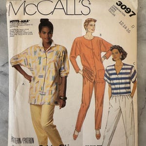 May include: A McCall's sewing pattern envelope with illustrations of women's clothing designs. The envelope includes the text "PETITE-ABLE" and "Cut-to-Fit". The designs include a button-up shirt and trousers set, and a striped shirt with trousers.